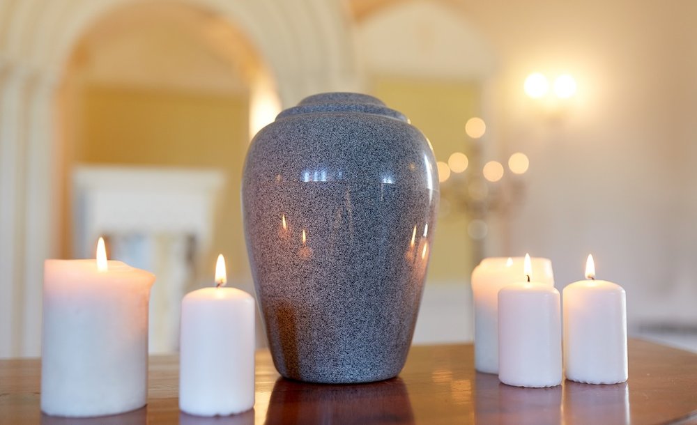 A Urn Surrounded By Candles